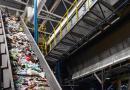 A conveyor belt in a recycling facility transporting recyclable materials that have yet to be sorted.